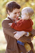 A young mother holding her baby, smiling