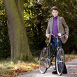 A young woman standing with her bicycle