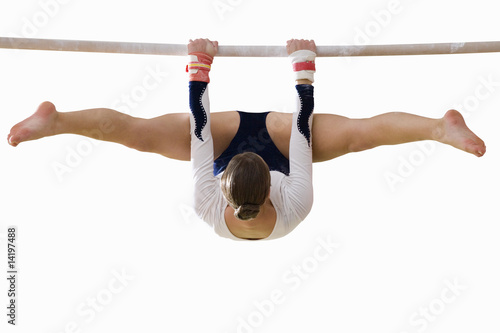 Photo: Female gymnast performing on bar, cut out Female gymnast performing on bar, cut out