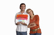 Photo: Woman leaning against boyfriend, man holding pile of folded towels, smiling, front view, portrait, cut out Woman leaning against boyfriend, man holding pile of folded towels, smiling, front view, portrait, cut out