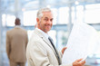 Mature architect studying a blueprint