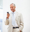 Senior business man messaging using a mobile phone