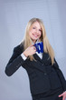 Young blond business woman holding cup of coffee