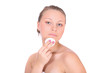 Foto: A beautiful young woman taking care of her face A beautiful young woman taking care of her face