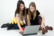 Young girls sitting on the floor with laptop