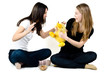 Girls playing with a yellow duck