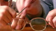 hands child with senior repair glasses