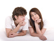 Happy young couple on bed.
