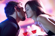 Young lovers kissing in restaurant, celebrating or on date Young lovers kissing in restaurant, celebrating or on date