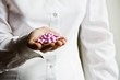 A doctor holding a handful of vitamin supplement capsules A doctor holding a handful of vitamin supplement capsules