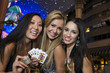 Photo: Portrait of three young women with playing cards, gambling chips and champagne in front of casino, Las Vegas, Nevada, USA Portrait of three young women with playing cards, gambling chips and champagne in front of casino, Las Vegas, Nevada, USA