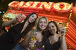 Photo: Portrait of three young women toasting in front of illuminated casino, Las Vegas, Nevada, USA Portrait of three young women toasting in front of illuminated casino, Las Vegas, Nevada, USA