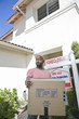 Sad mid adult man moving out of house