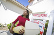Sad mid adult woman moving out of house