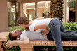 Photo: attractive woman leaning over man grabbing his stomach attractive woman leaning over man grabbing his stomach