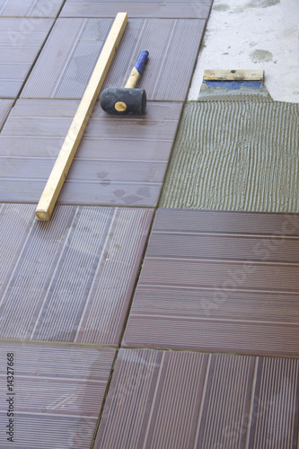 Photo: tile-layer who poses tiling on a terrace tile-layer who poses tiling on a terrace