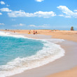 Sea landscape with people relaxing on the beach