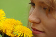 Beautiful girl in a field enjoying the sun and smelling the flow