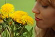 Beautiful girl in a field enjoying the sun and smelling the flow