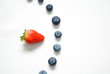 Strawberry pointing at blueberry