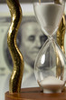 hourglass on big dollar background hourglass on big dollar background