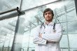 Portrait of a doctor outdoors in front of modern clinic Portrait of a doctor outdoors in front of modern clinic