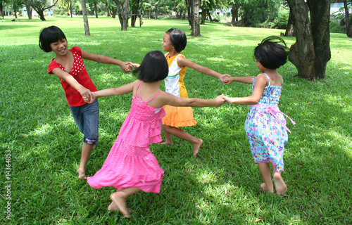 Photo: Four girls playing in the park. Four girls playing in the park.