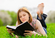 Pretty girl reading outdoors