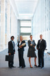 Business associates standing in line at the hallway