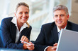 Happy successful business colleagues at work
