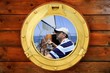 Sailor on sailboat, from boat round window