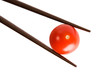 Bamboo chopsticks and cherry tomato on white background Bamboo chopsticks and cherry tomato on white background