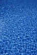 Blue water texture, tiles pool in sunny day
