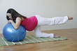 Young pregnant woman doing leg muscle exercise.