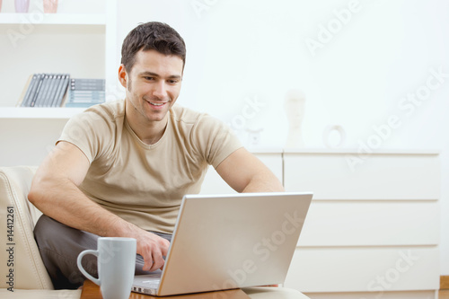 Photo: Happy man using computer Happy man using computer