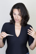 Woman taking temperature or watching a pregnancy test