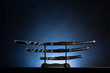 Photo: Katana, wakizashi and tanto on blue background. Copy space. Katana, wakizashi and tanto on blue background. Copy space.