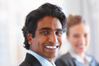 Young business man with colleague in the background