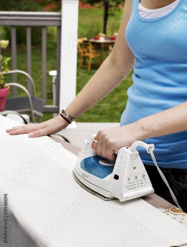 Photo: Young Woman Ironing Young Woman Ironing