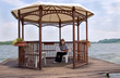 Woman working with pc on lake shore