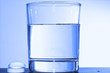 Two effervescent tablets and glass with water Two effervescent tablets and glass with water