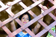 Pretty girl in wooden cage