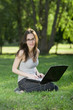 student with laptop outdoors