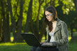 student with laptop outdoors