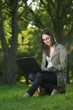 student with laptop outdoors