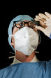 Surgeon looks down at patient Surgeon looks down at patient