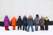 Children stand  having joined hands, back view