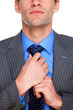 Businessman doing his tie up
