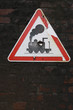Old red black and white rail road caution sign