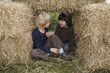 Two boys in hay bales Two boys in hay bales